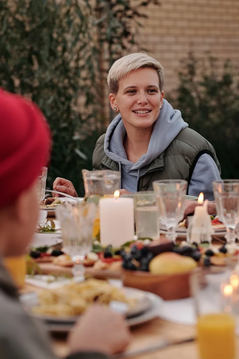 A group of friends laughing together over dinner — the hangout that finally happened